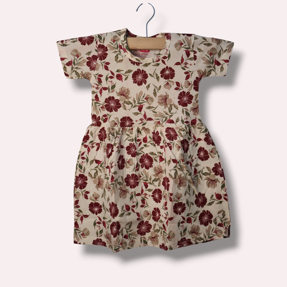 Cream baby short sleeve frock with maroon and green floral printed design