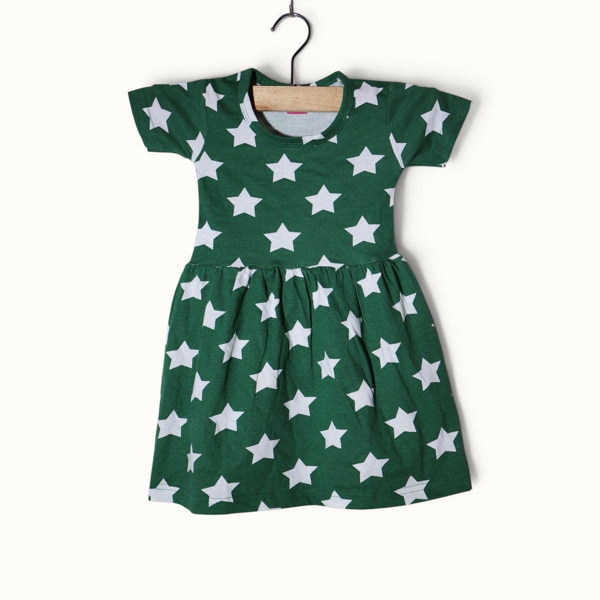 Green baby short sleeve frock with white star printed design.