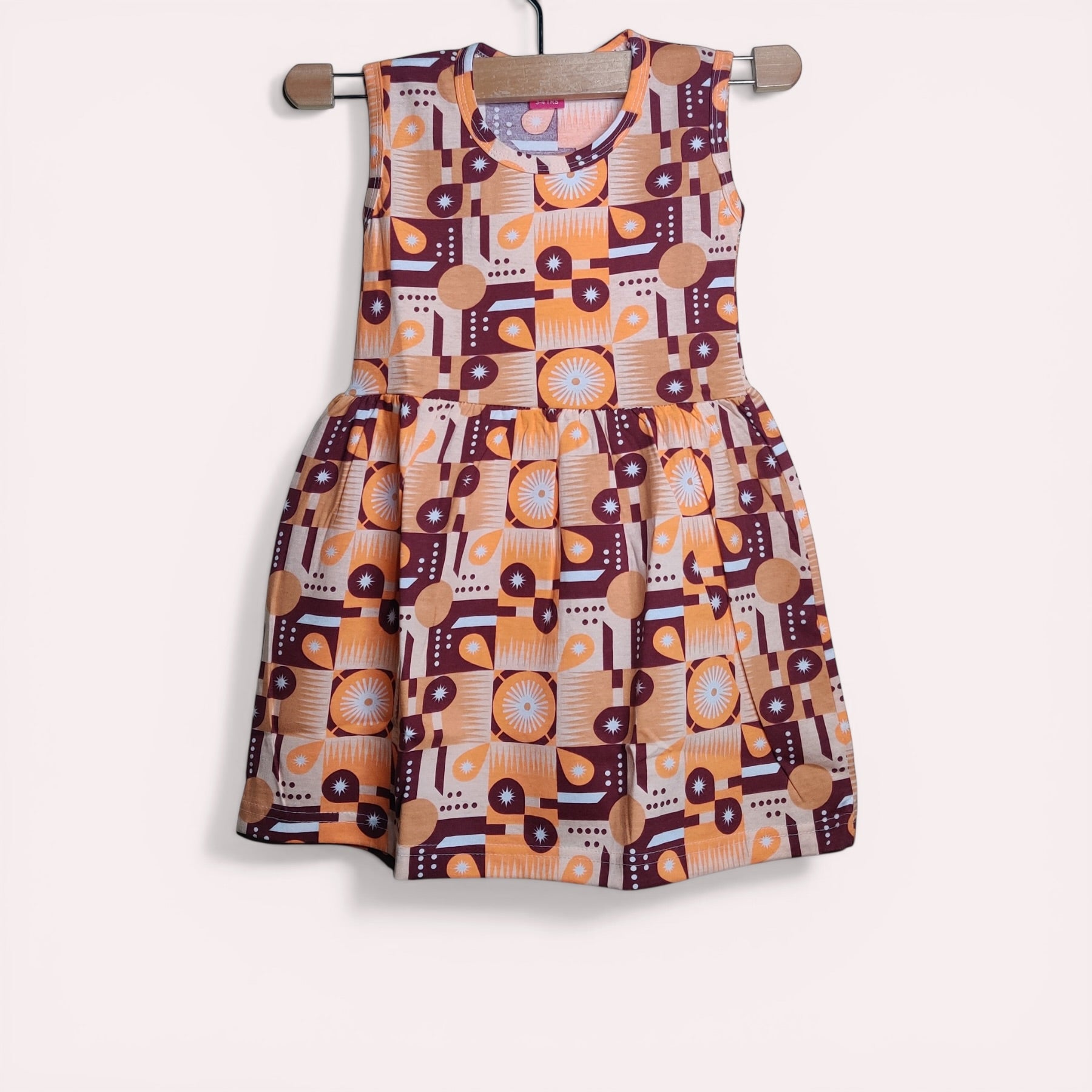 Amber baby frock with printed geometric design