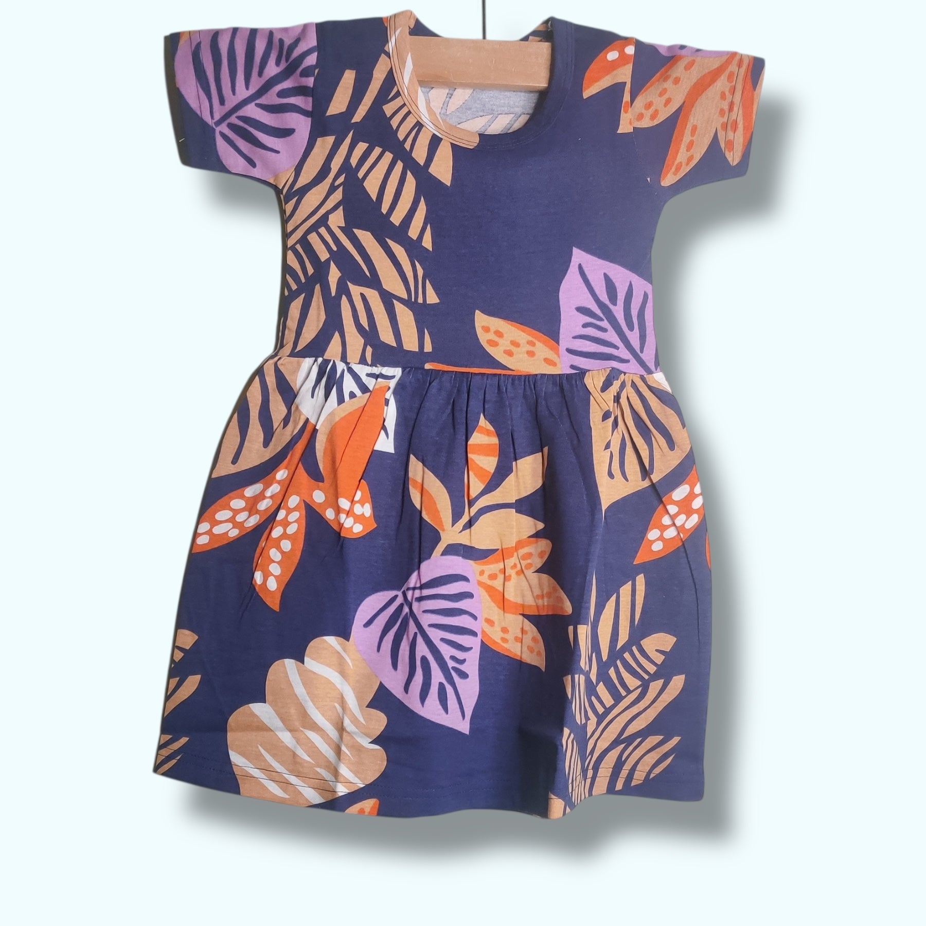 Deep navy baby frock with colorful leaf printed design