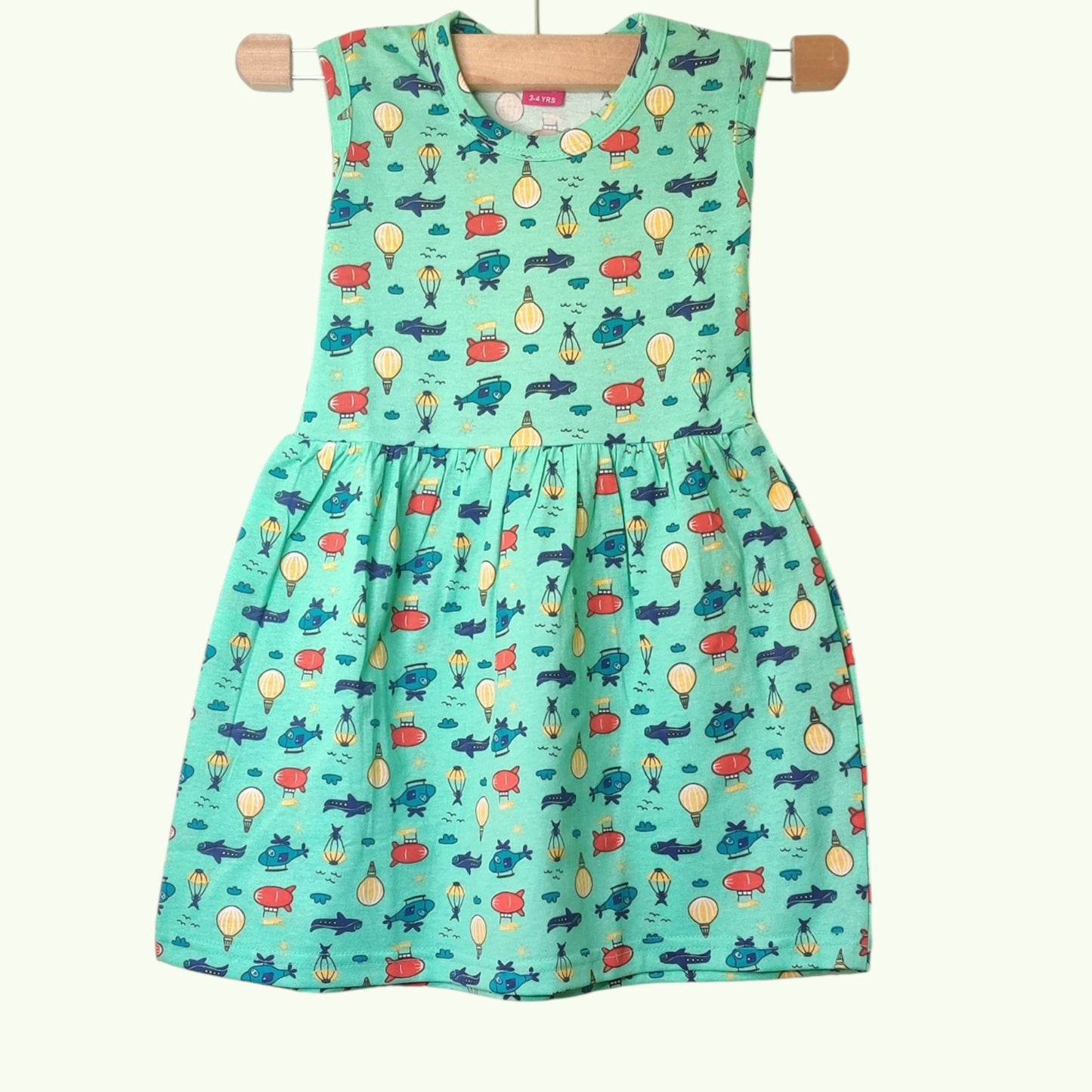 Fresh green baby frock with printed airplane and balloon design