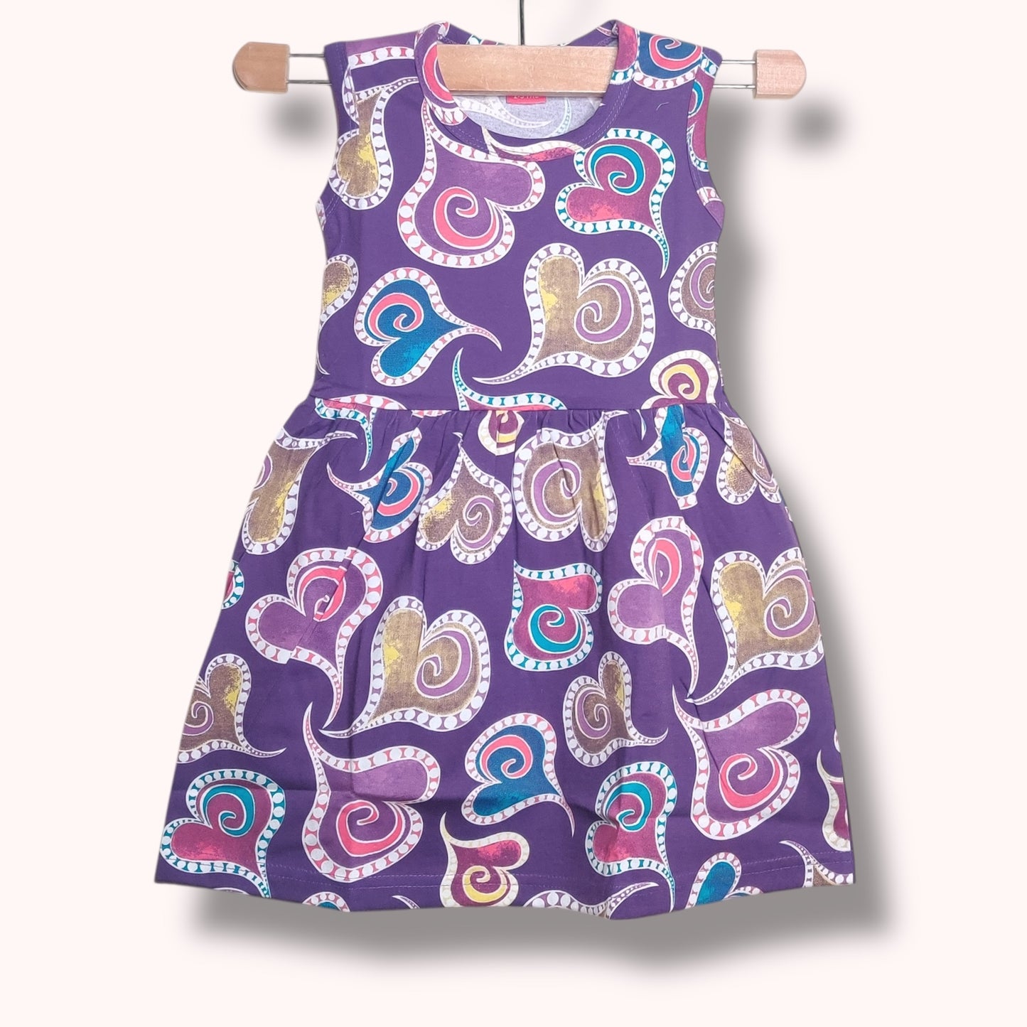 Lavender purple baby frock with multicolor heart swirl printed design
