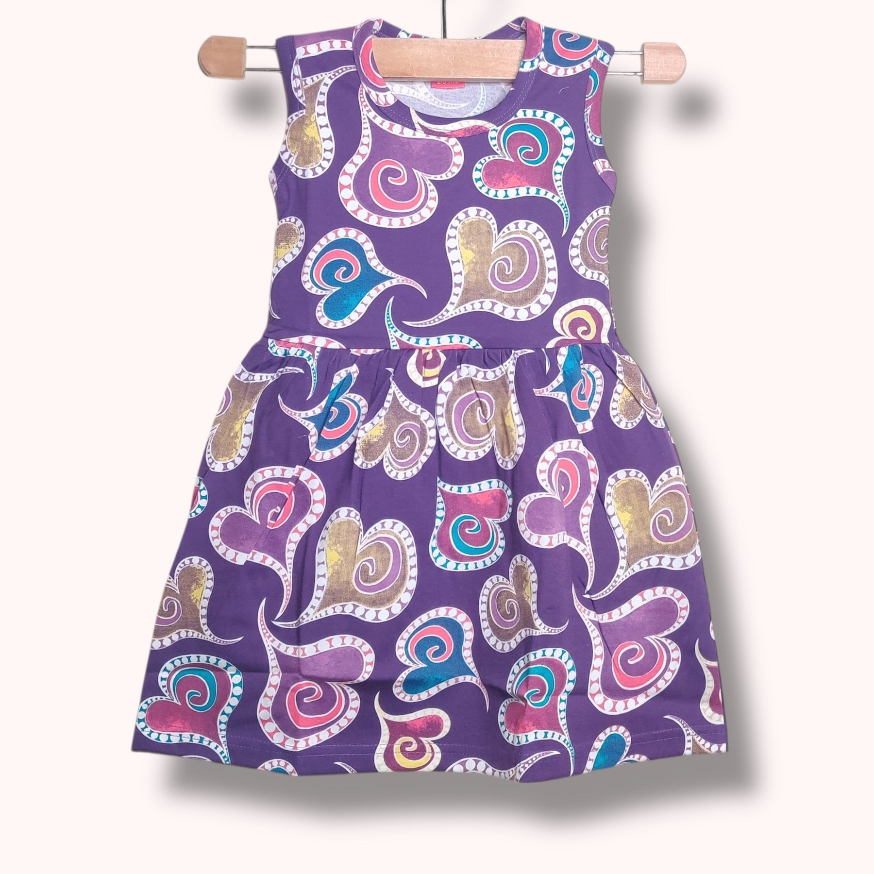 Lavender purple baby frock with multicolor heart swirl printed design