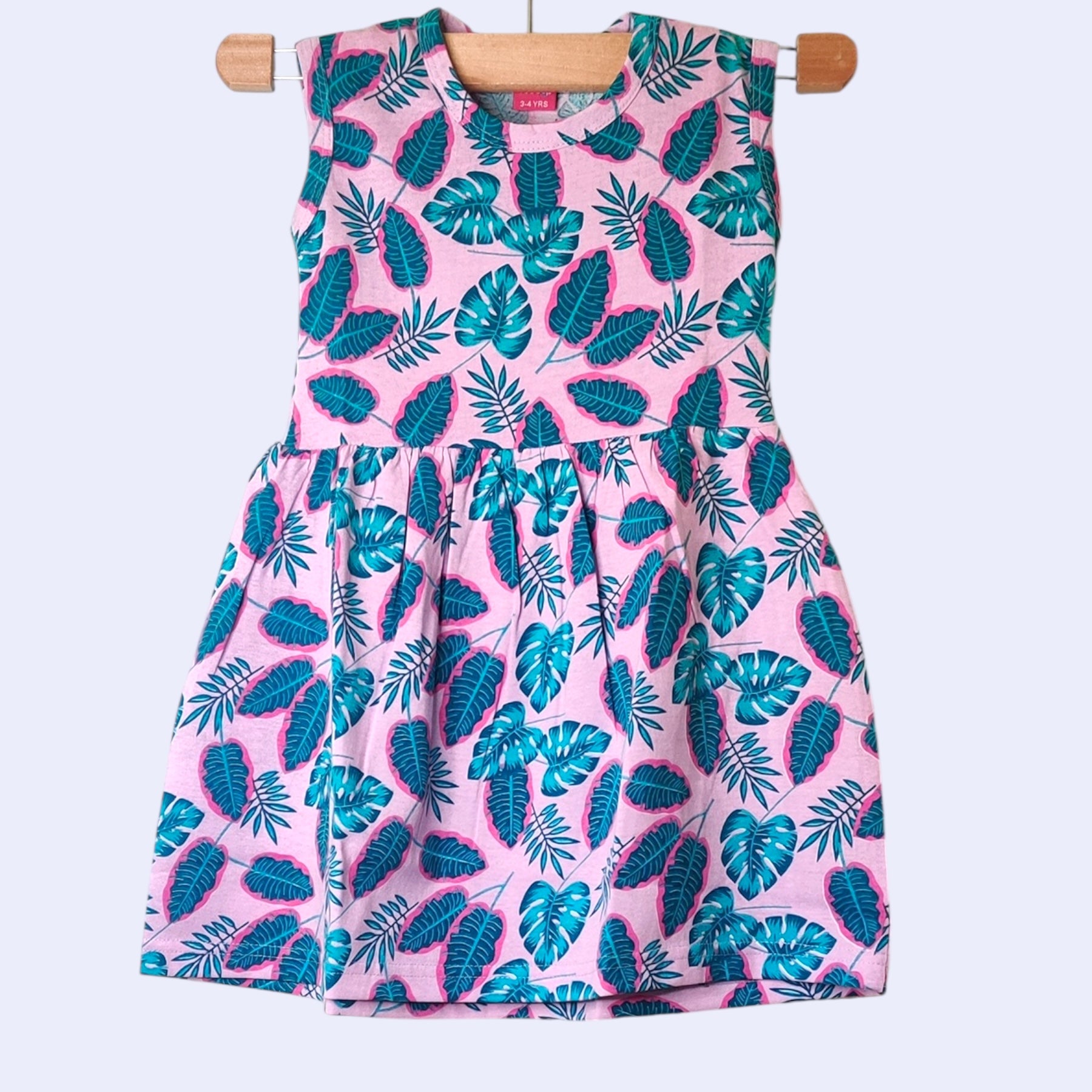 Lilac pink baby frock with printed tropical leaf design