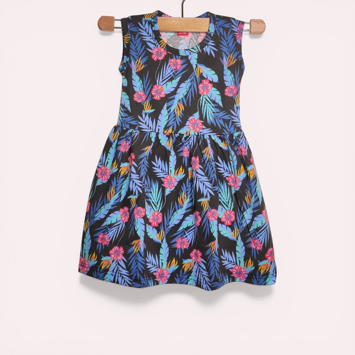 Midnight tropic baby frock with printed floral and leaf design