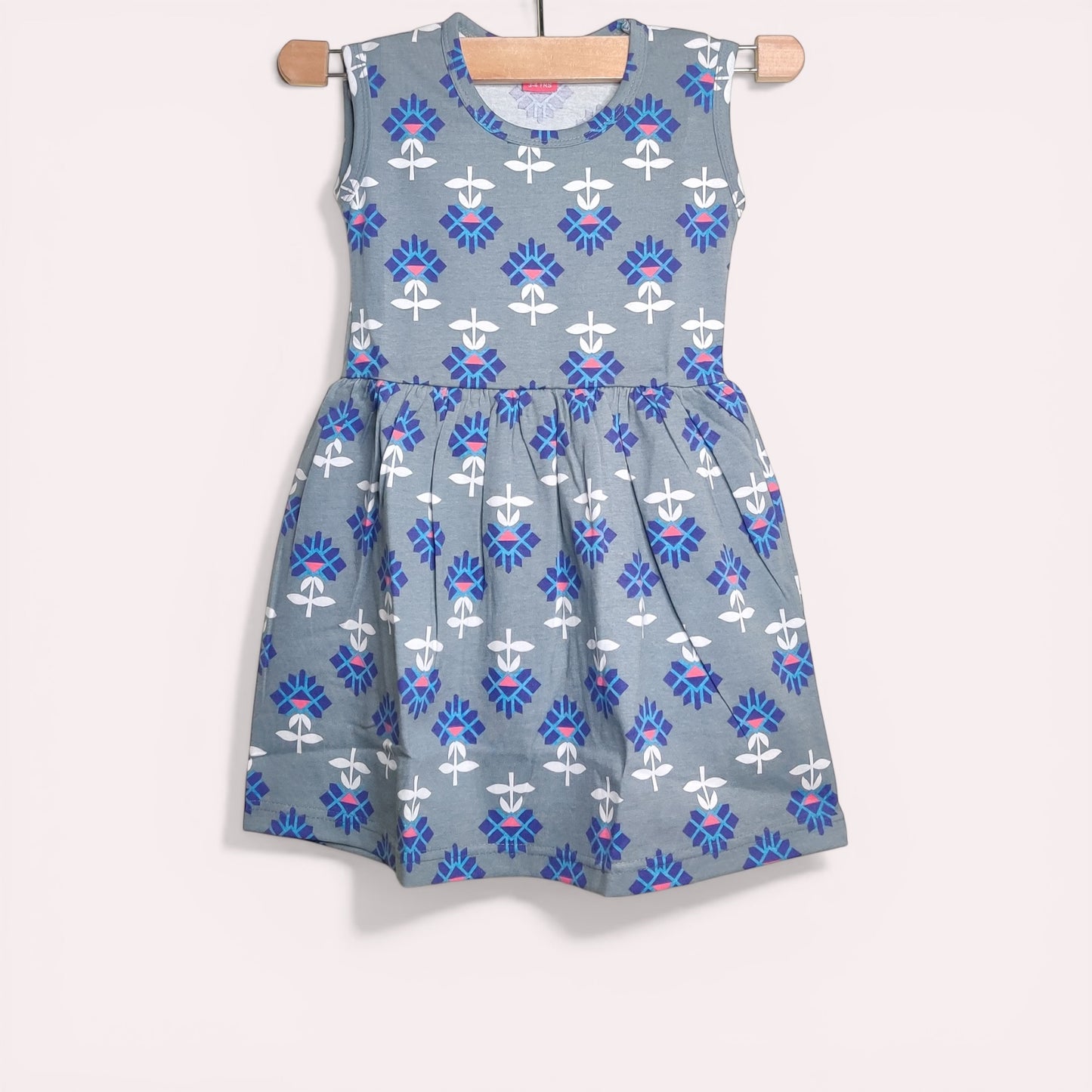 Misty blue baby frock with printed geometric floral design
