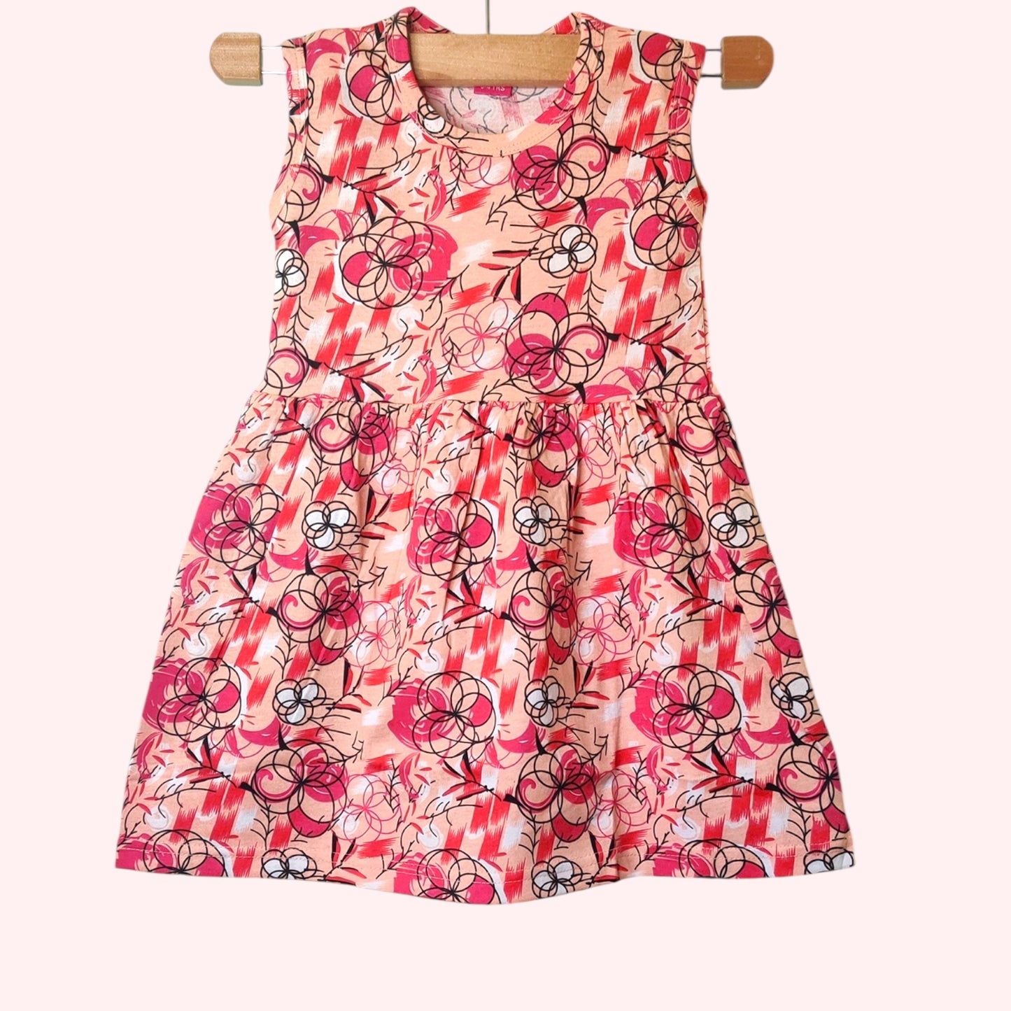 Peach blossom baby frock with printed floral and abstract design