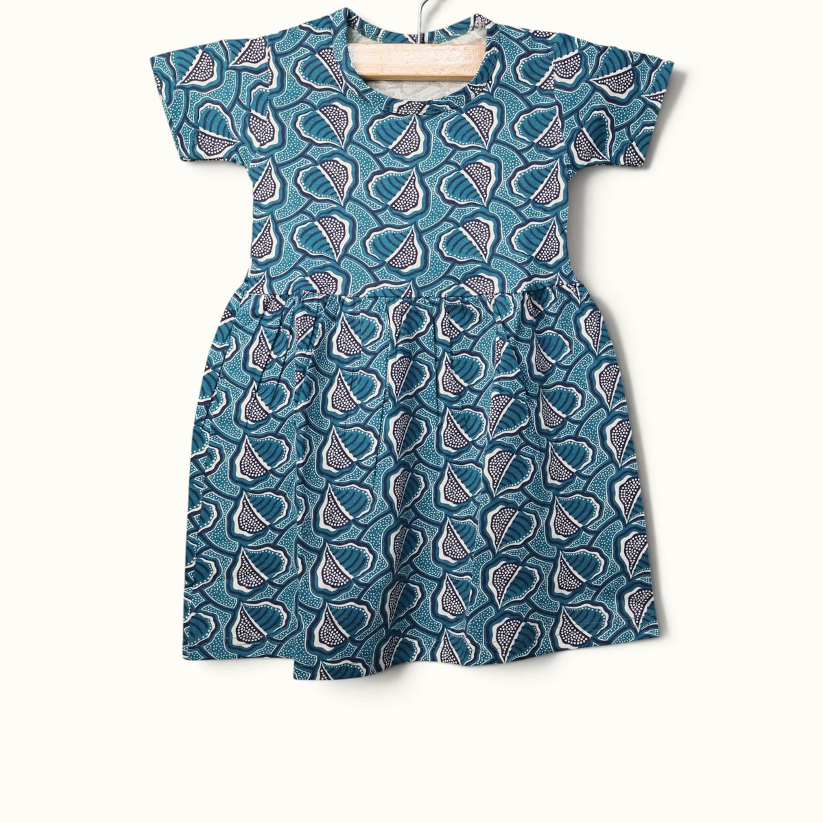 Sea green baby frock with abstract leaf printed design