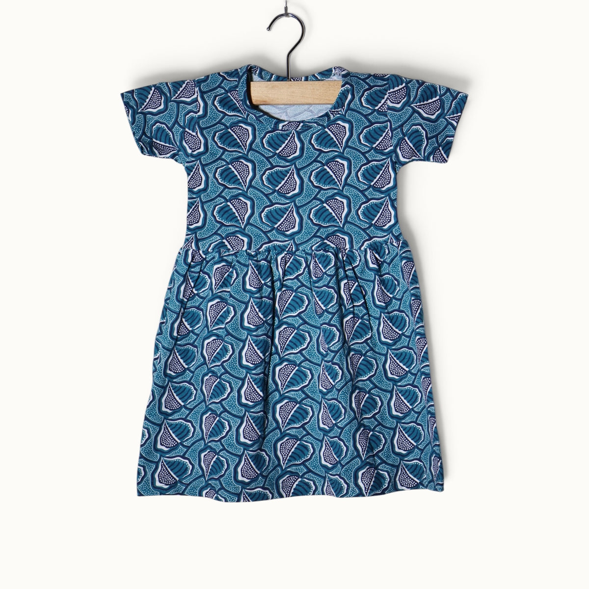 Sea green baby frock with abstract leaf printed design