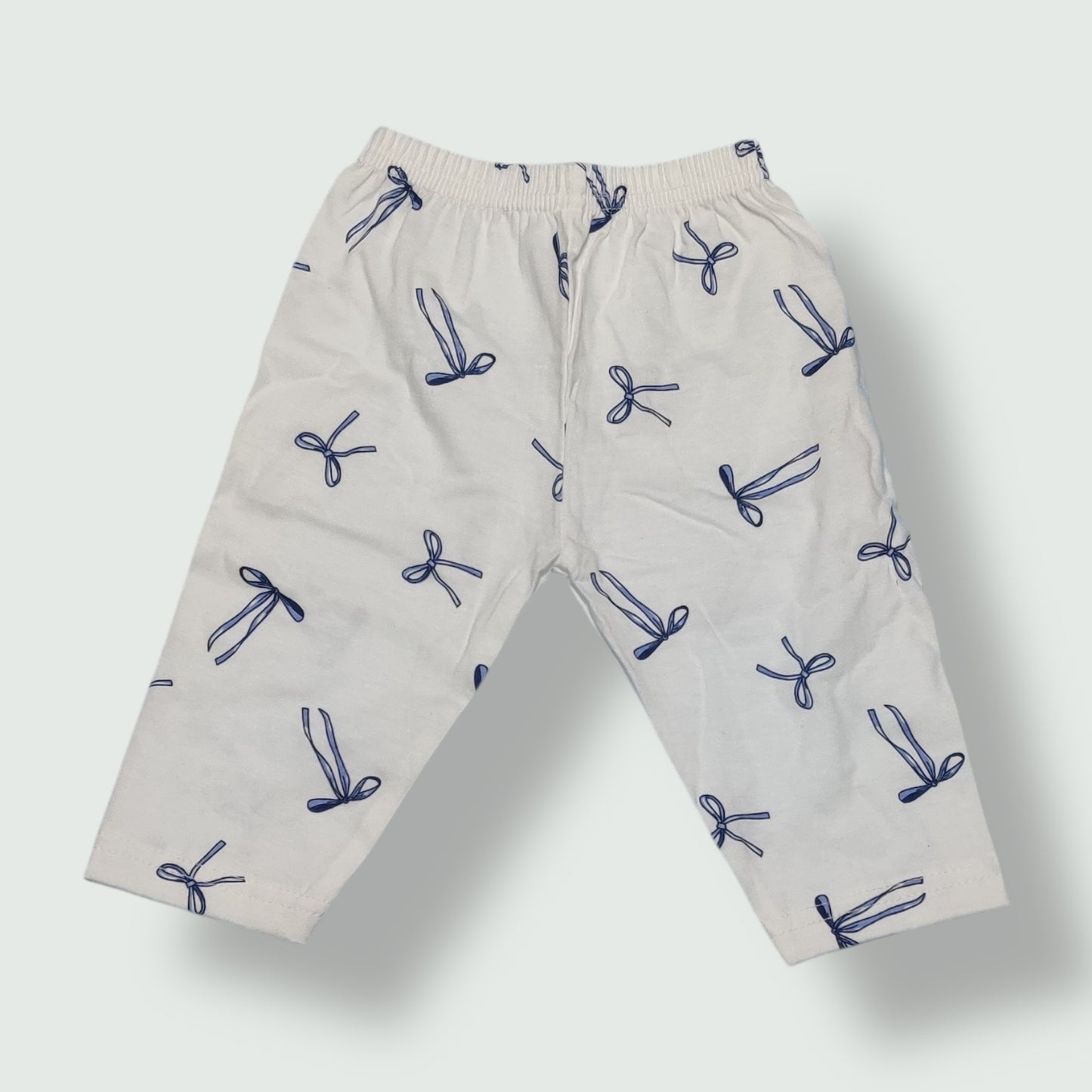 Pearl white cotton baby pant with navy blue bow print front view