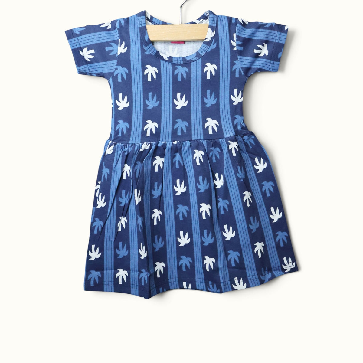 Blue baby short sleeve frock with white and light blue palm tree stripe printed design.