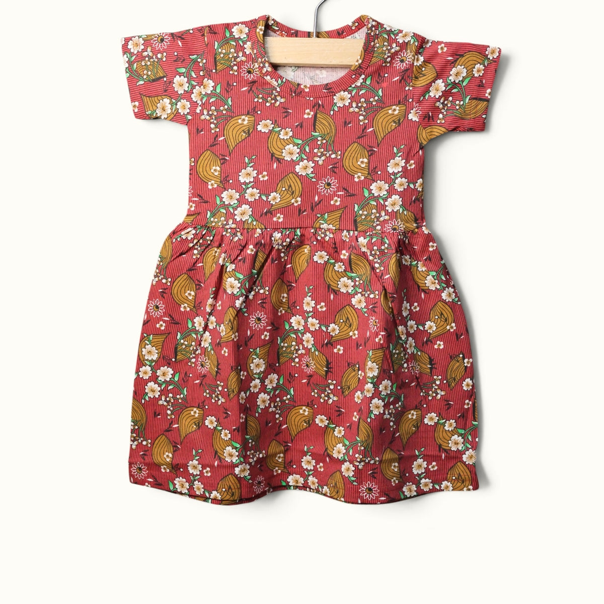 Dusty red baby short sleeve frock with floral and leaf printed design.