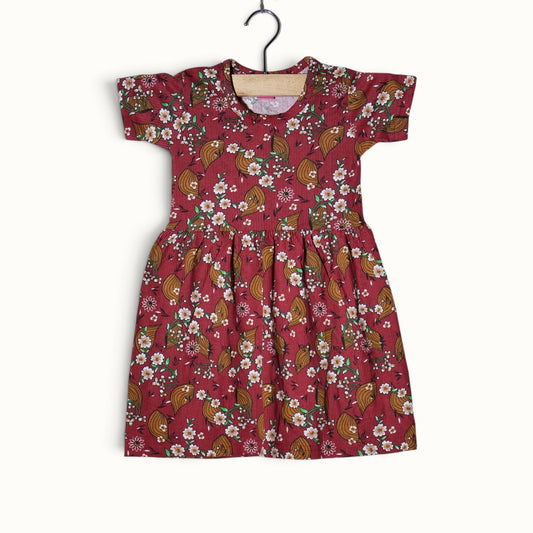 Dusty red baby short sleeve frock with floral and leaf printed design.