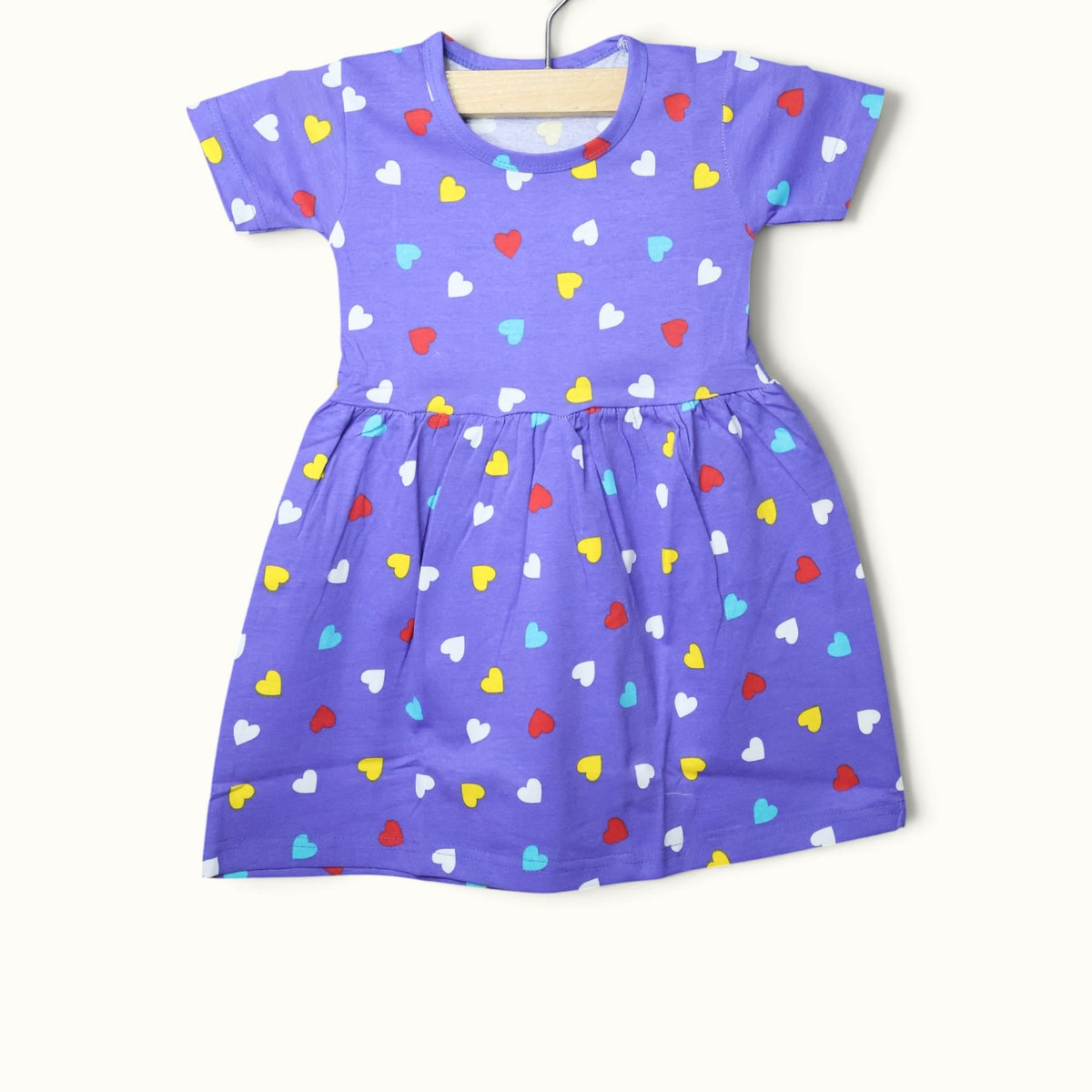 Lavender baby short sleeve frock with colorful heart printed design.