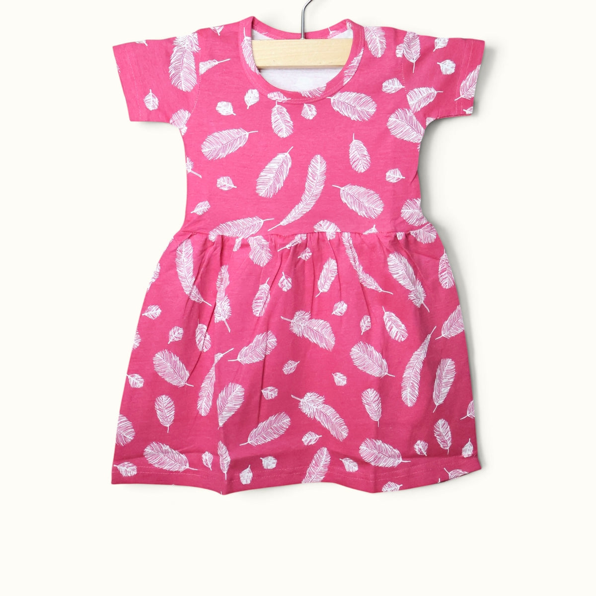 Pink baby short sleeve frock with colorful feather printed design.