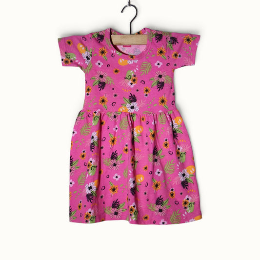 Pink baby short sleeve frock with colorful floral and leafy printed design.