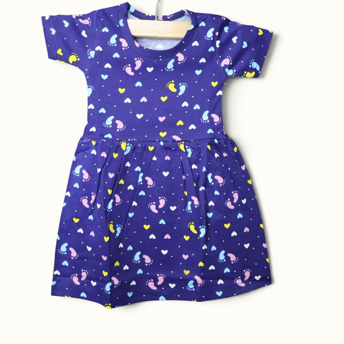 Purple baby short sleeve frock with colorful footprint and heart printed design.