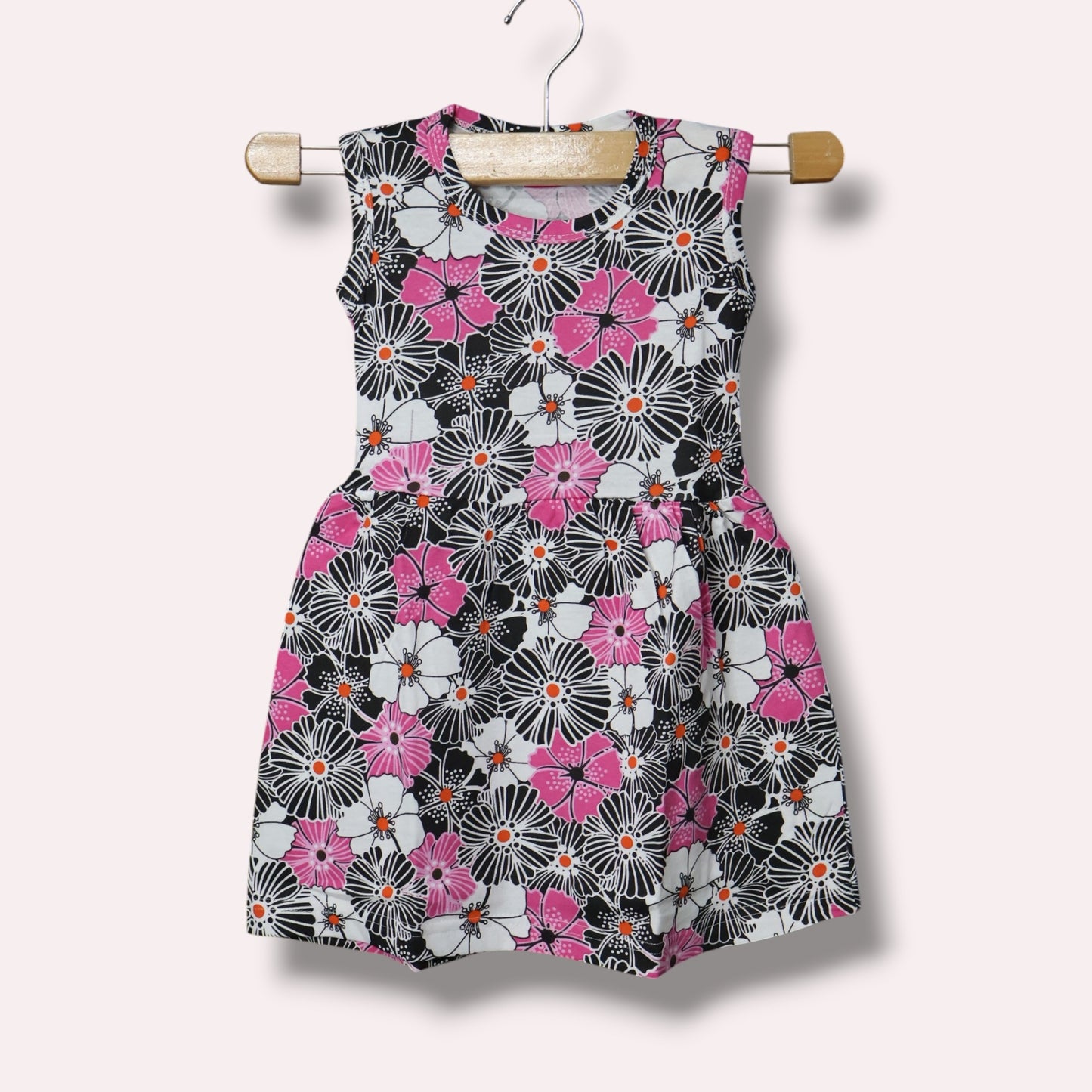 Multicolor baby sleeveless frock with black, pink and white floral printed design