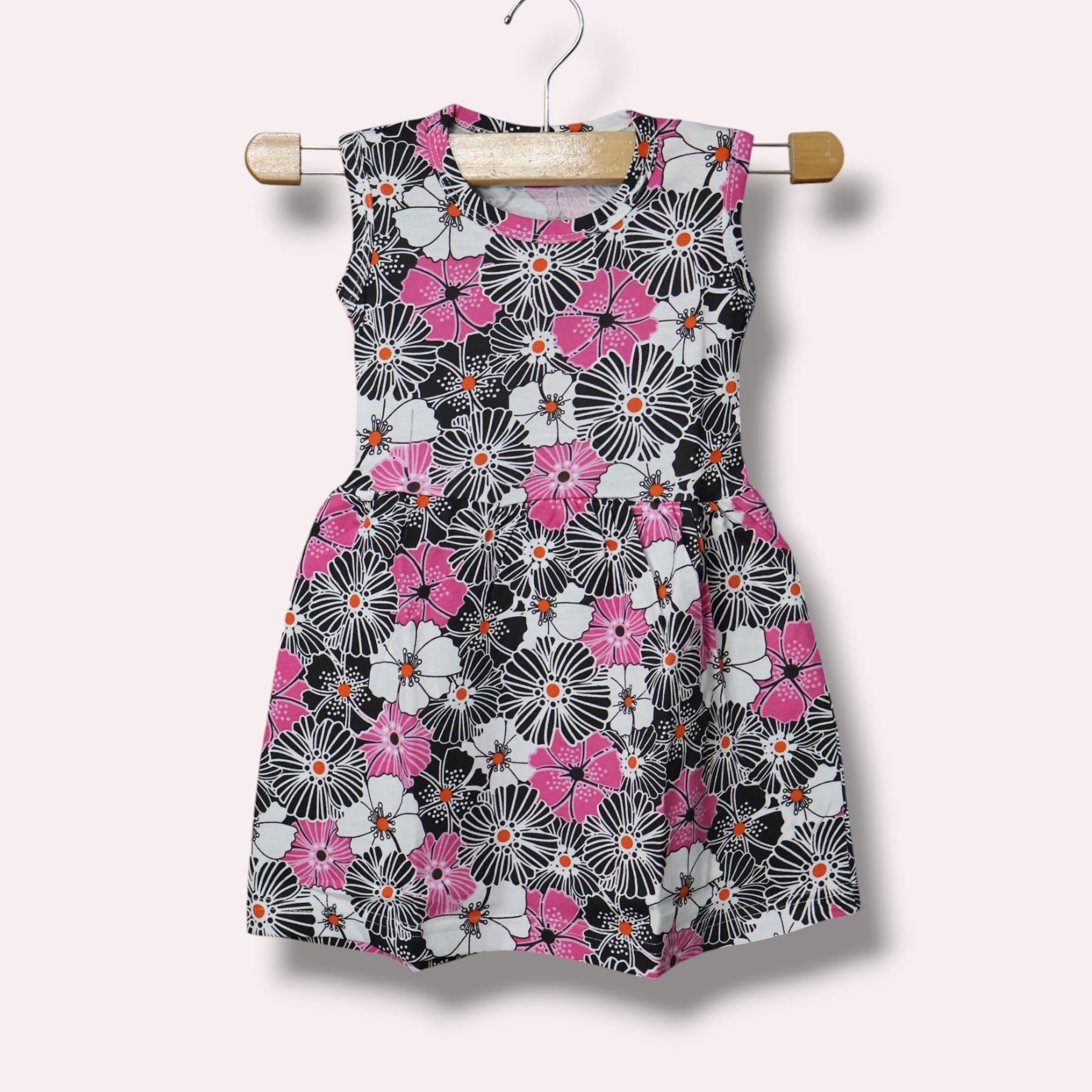 Multicolor baby sleeveless frock with black, pink and white floral printed design