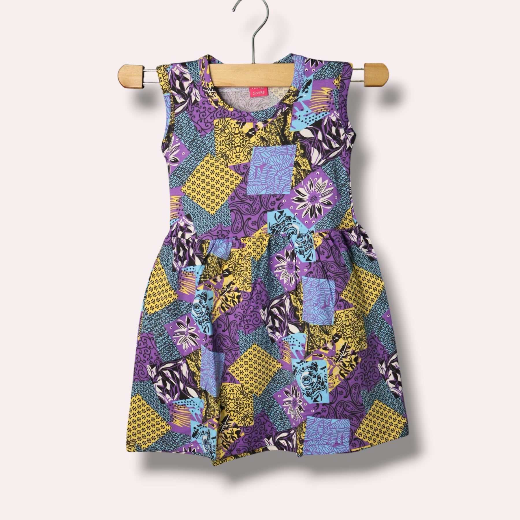 Purple yellow baby sleeveless frock with geometric and floral printed design