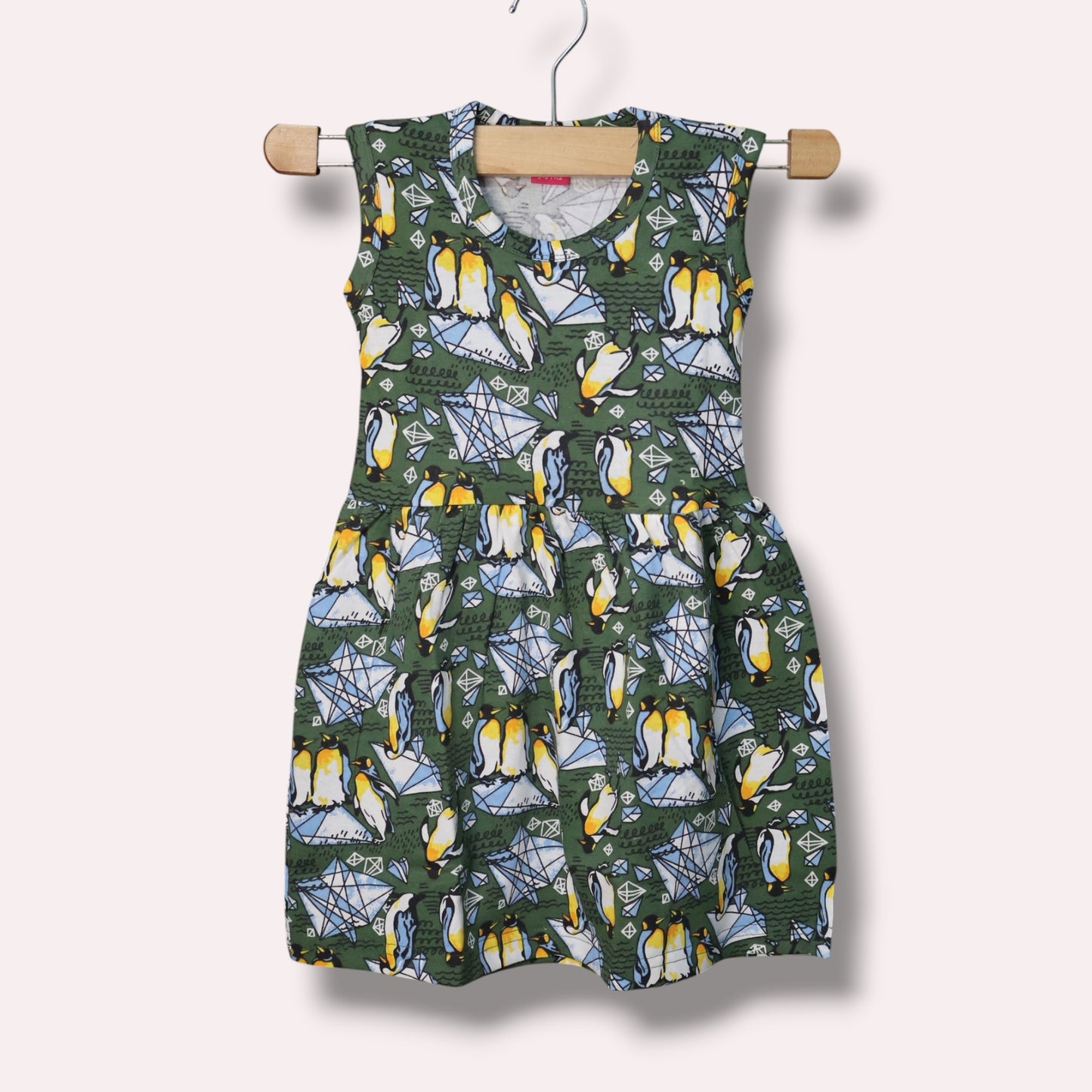 Forest green baby sleeveless frock with penguin and geometric printed design
