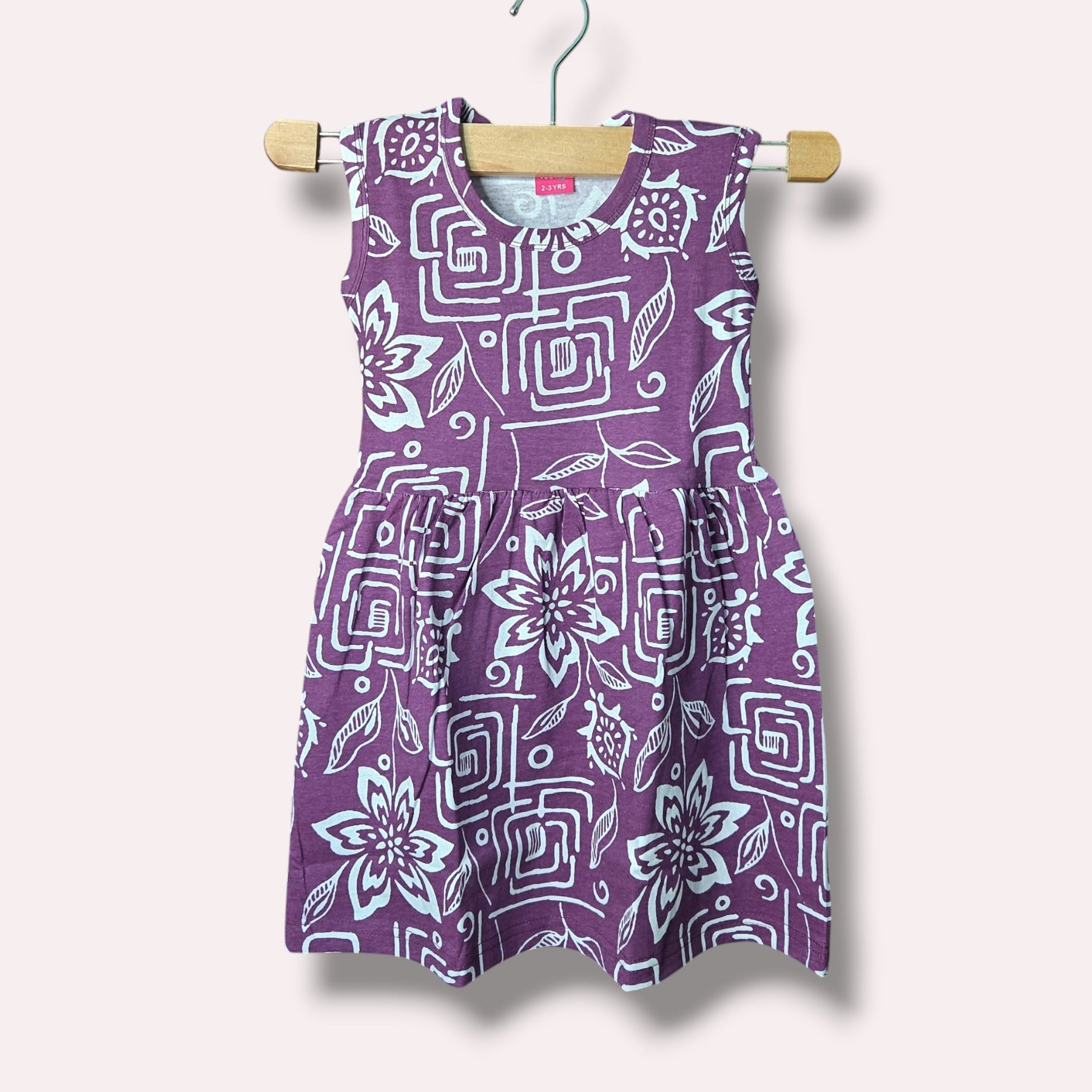 Purple baby sleeveless frock with floral and geometric printed design