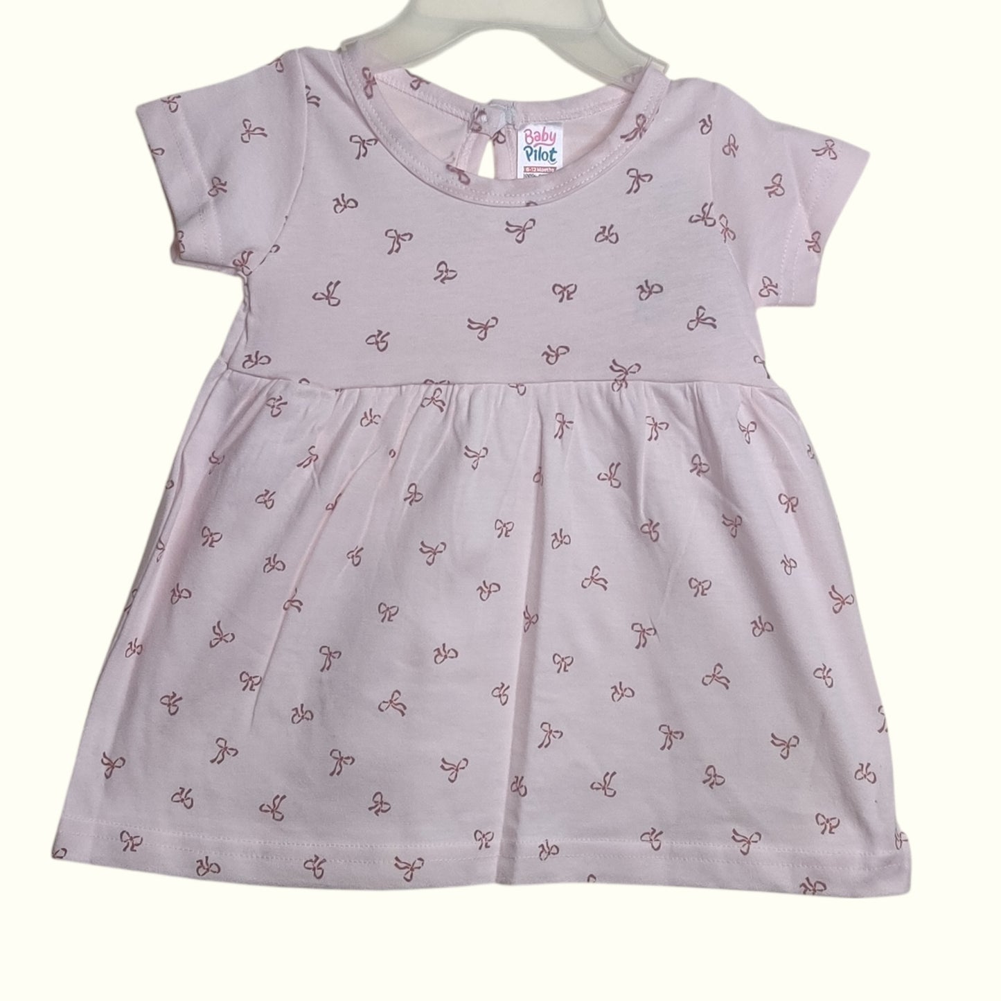 Soft blush beige baby frock with printed bow design
