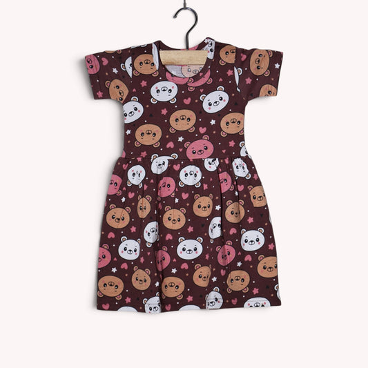 Brown baby frock with an allover teddy bear and heart print in pink, white and tan, featuring short sleeves