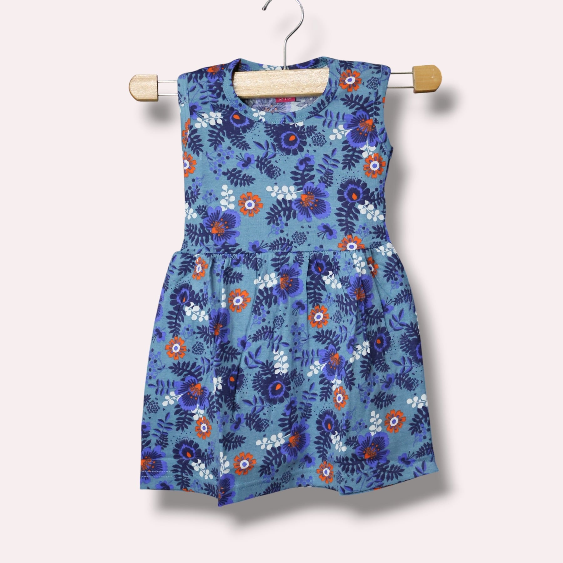 Sleeveless dusty blue baby frock with an allover floral print
