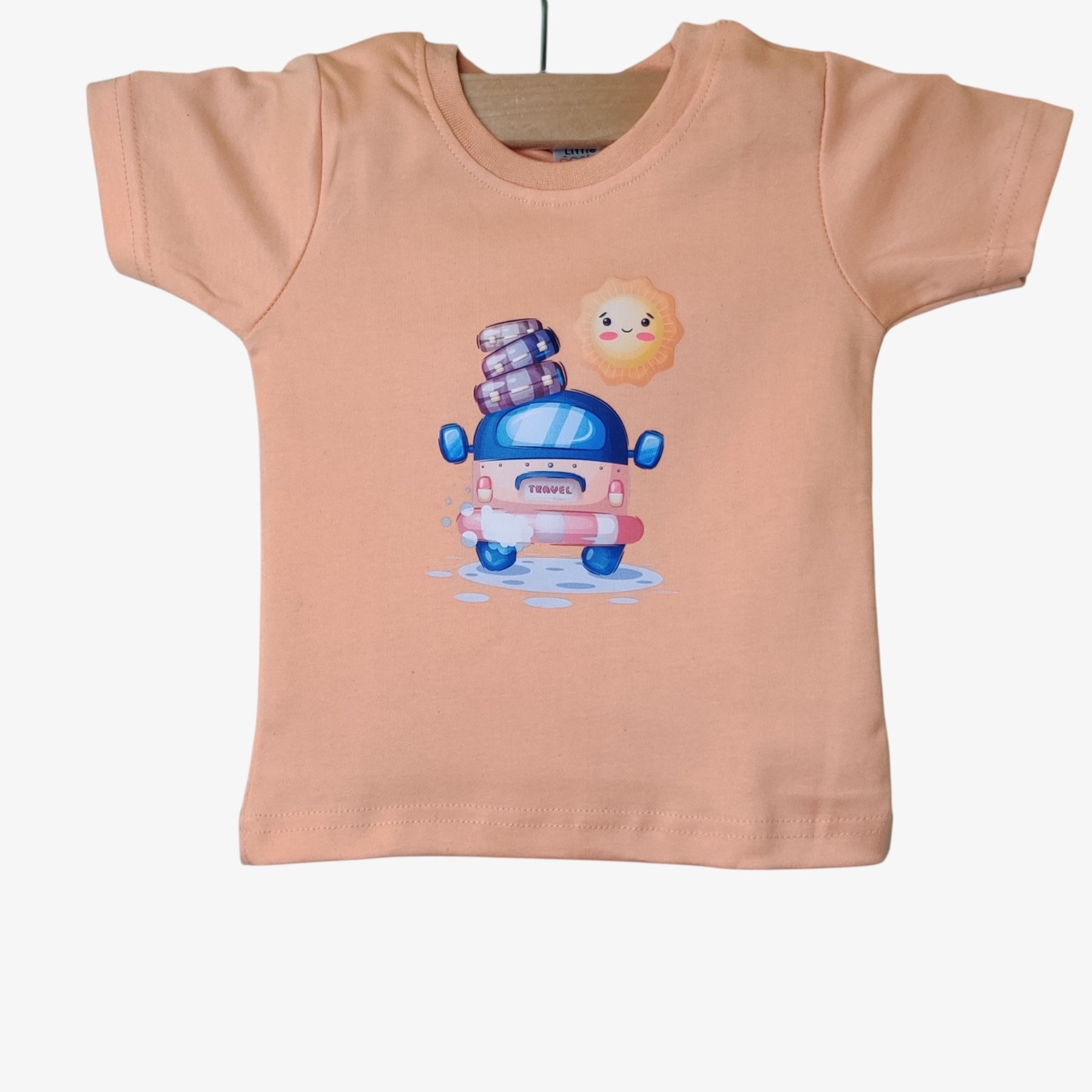 Front view of light orange soft cotton baby t-shirt with assorted chest print